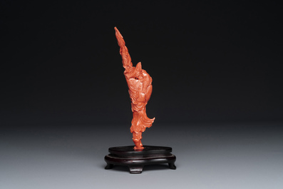 A Chinese red coral figure of a fisherman on wooden stand, 19/20th C.