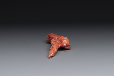 A Chinese red coral figure of a fisherman on wooden stand, 19/20th C.