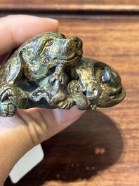 A group of four Chinese gilt bronze paper-weights, Ming/Qing