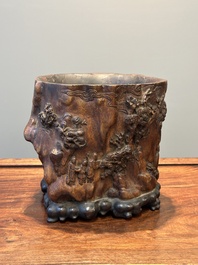 A large Chinese carved huanghuali wooden brush pot with Taoist design, 17/18th C.