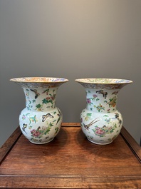 A pair of Chinese Canton famille rose spittoons with dragons, birds, butterflies and flowers, 19th C.