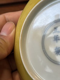 A pair of Chinese monochrome yellow-glazed saucers with incised designs of pine and cranes, Yongzheng mark and of the period