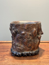 A large Chinese carved huanghuali wooden brush pot with Taoist design, 17/18th C.