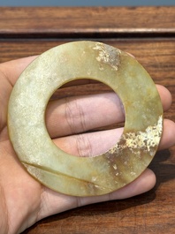 A Chinese celadon and russet jade 'bi' disc, probably Han