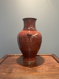 A Chinese monochrome red-glazed 'hu' vase, Qianlong mark, 19th C.