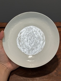 A Chinese monochrome white-glazed anhua 'dragon' plate, 18th C.