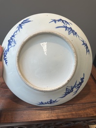 A Chinese blue and white teapot with landscape design and an 'antiquities' dish, 19th C.