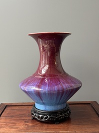 A Chinese flamb&eacute;-glazed vase on a wooden stand, 19th C.