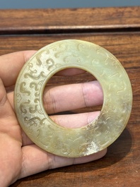 A Chinese celadon and russet jade 'bi' disc, probably Han