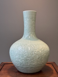 A pair of large Chinese monochrome celadon-glazed anhua 'lotus scroll' bottle vases, 19th C.