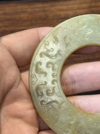A Chinese celadon and russet jade 'bi' disc, probably Han