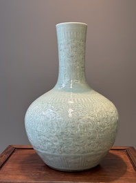 A pair of large Chinese monochrome celadon-glazed anhua 'lotus scroll' bottle vases, 19th C.