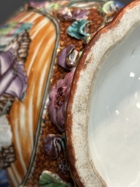 A pair of Chinese Canton famille rose 'mandarin subject' vases with floral relief design, Qianlong