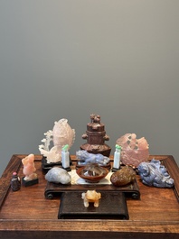 A group of Chinese carvings of lapis lazuli, pink quartz and other precious stones, with several stands, 19/20th C.