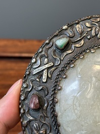 A Chinese white jade-mounted and gemstone inlaid silver hand mirror, 19/20th C.