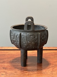 A Chinese archaistic bronze tripod censer on wooden stand, 'ding', Song/Ming