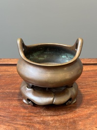 A Chinese bronze tripod censer on a stand, Xuande mark, 19th C.