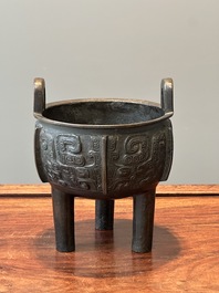 A Chinese archaistic bronze tripod censer on wooden stand, 'ding', Song/Ming