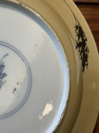 A Chinese famille verte caf&eacute;-au-lait ground plate and a monochrome white plate, Kangxi