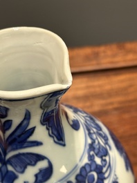 A Chinese blue and white ewer with figures in a landscape, Transitional period