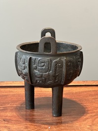 A Chinese archaistic bronze tripod censer on wooden stand, 'ding', Song/Ming