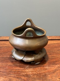 A Chinese bronze tripod censer on a stand, Xuande mark, 19th C.