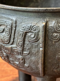 A Chinese archaistic bronze tripod censer on wooden stand, 'ding', Song/Ming