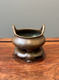 A Chinese bronze tripod censer on a stand, Xuande mark, 19th C.