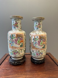 A pair of Chinese Canton famille rose vases with wooden stands, 19th C.