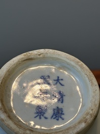 A pair of Chinese blue and white covered vases and three jars, 19th C.