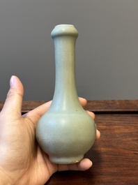 A Chinese celadon-glazed bottle vase and two bowls, Yuan/Ming