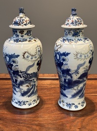 A pair of Chinese blue, white and copper-red vases and covers, Kangxi mark, 19th C.