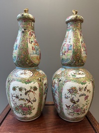 A pair of Chinese Canton famille rose double gourd vases and covers, 19th C.