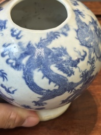 A pair of Chinese blue and white covered vases and three jars, 19th C.