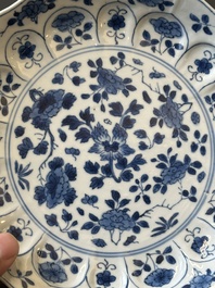 A pair of Chinese blue and white 'Mongolian hunting scene' plates and a pair of plates with floral design, Chenghua and Kangxi mark, Kangxi