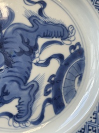 A pair of Chinese blue and white 'Buddhist lion' plates, ding mark, Kangxi