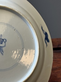 A pair of Chinese blue and white 'Buddhist lion' plates, ding mark, Kangxi