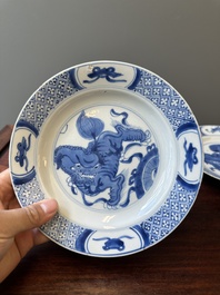 A pair of Chinese blue and white 'Buddhist lion' plates, ding mark, Kangxi