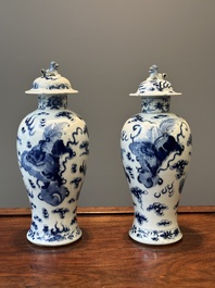 A pair of Chinese blue and white covered vases and three jars, 19th C.