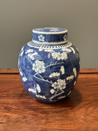 A pair of Chinese blue and white covered vases and three jars, 19th C.