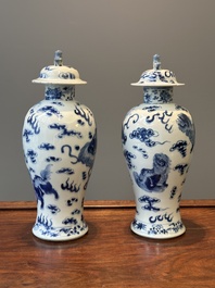 A pair of Chinese blue and white covered vases and three jars, 19th C.