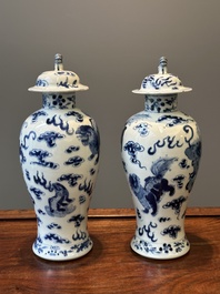 A pair of Chinese blue and white covered vases and three jars, 19th C.