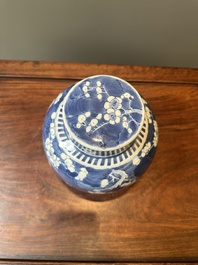 A pair of Chinese blue and white covered vases and three jars, 19th C.