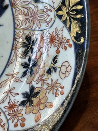 A Japanese Imari dish with carps among waves and clouds, Edo, 17th C.