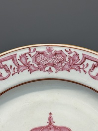 A pair of monogrammed Chinese puce-enamelled plates and a pair of armorial cups and saucers, Yongzheng/Qianlong