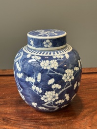 A pair of Chinese blue and white covered vases and three jars, 19th C.