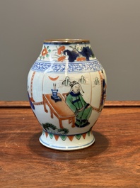 A Chinese wucai vase with figures and calligraphy, 19th C.