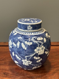 A pair of Chinese blue and white covered vases and three jars, 19th C.