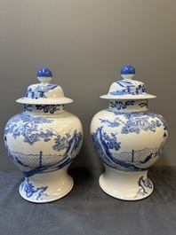 A pair of Chinese blue and white covered vases with figural design, 19th C.