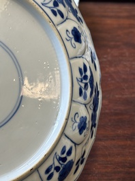 A pair of Chinese blue and white 'Mongolian hunting scene' plates and a pair of plates with floral design, Chenghua and Kangxi mark, Kangxi